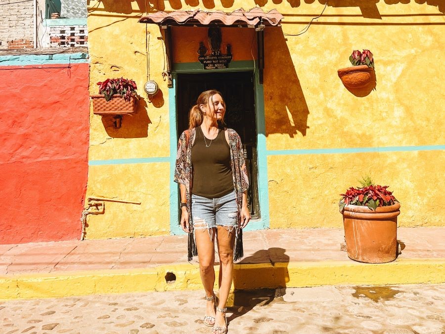 Annette in front of a colorful house in El Quelite
