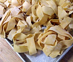 homemade pappardelle pasta in a haystack