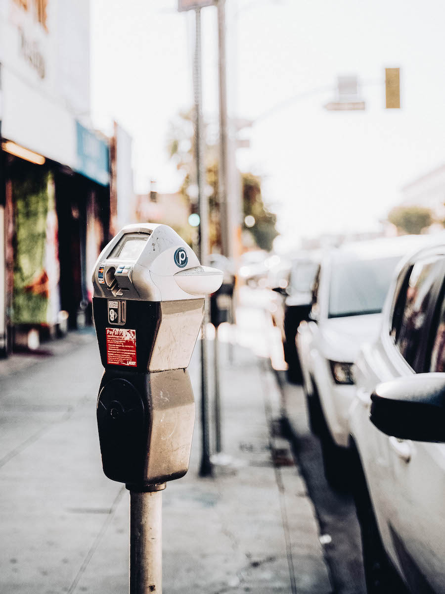 Parking meter on a street with cars