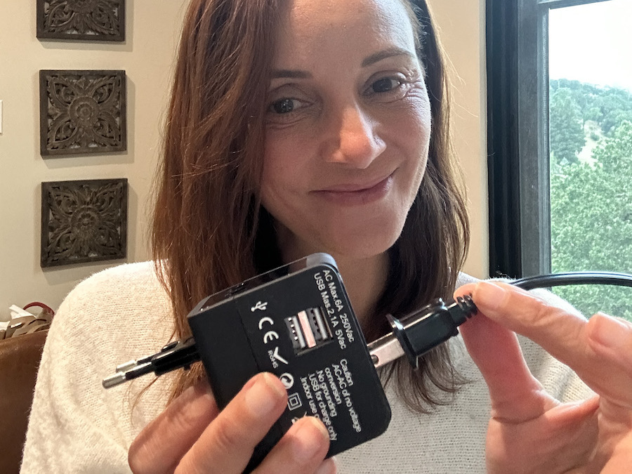 Annette holding a universal adapter